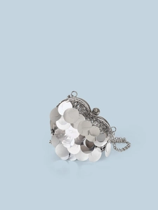 Close-up of heart-shaped silver sequin clutch bag with metal chain and spherical clasp