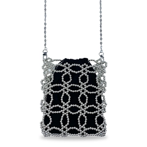 Detailed shot of silver beaded hollow crossbody bag with black drawstring liner