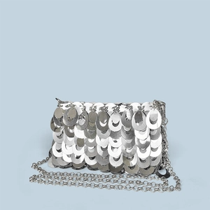 Detailed view of silver sequin chain bag with metallic fish scale texture and slim strap