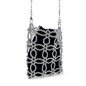 Detail of handcrafted silver beaded mini bag with black drawstring liner and metal chain