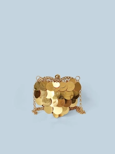 Detail of a heart-shaped sequin crossbody bag with large golden scales and a chain strap