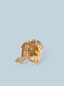 Detail of a gold spherical sequin clutch bag with metal frame and delicate chain strap