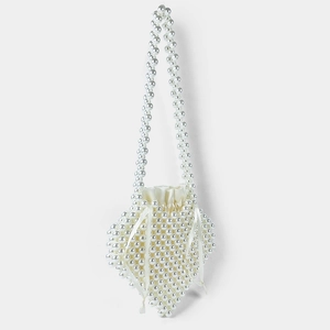 Detail of handmade pearl heart-shaped handbag with satin lining and beaded handle