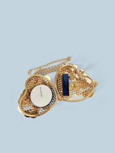 Golden heart-shaped metal sequin crossbody bag with chain strap and interior storage view