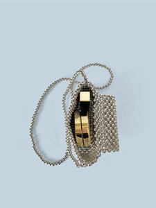Detailed interior of handmade silver beaded crossbody bag with square metal cosmetic case