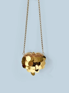 Detailed view of the sparkling gold heart-shaped sequin clutch bag with metal chain