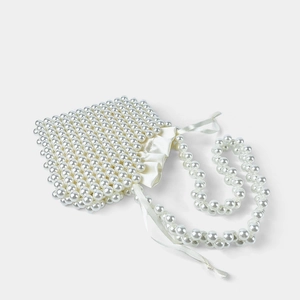 Detail of handmade pearl beaded handbag featuring white satin drawstring closure and strap