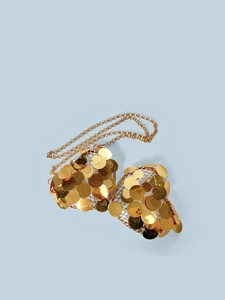 Detailed view of a gold sequin mesh bra top with metallic chain straps and heart frame