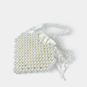 Close-up of white handmade pearl beaded heart bag with satin drawstring and shoulder strap