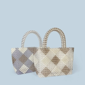 Detailed view of handmade beaded tote bags featuring elegant diamond weave patterns