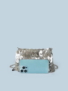 Silver sequin chain bag with metallic strap next to a phone for size comparison