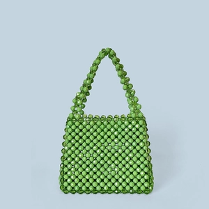 Close-up of green handcrafted acrylic beaded handbag with gradient green patterns