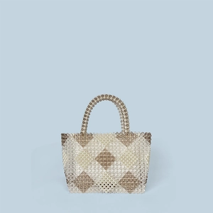 Close-up of handmade beaded tote bag with brown and white diamond geometric patterns