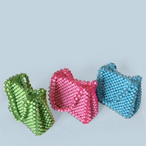 Detailed trio of handmade beaded handbags in green, pink, and blue with acrylic beads