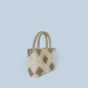 Detail of handcrafted beaded handbag featuring brown and clear diamond weave pattern