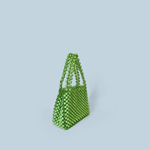 Detail of a handmade green faceted beaded handbag with woven texture and handle