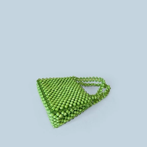 Detail of emerald green handmade beaded handbag with faceted transparent beads and handles
