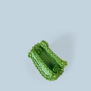 Detailed top view of handmade green beaded handbag with intricate woven bead patterns
