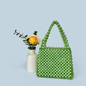 Detail of a handmade green beaded handbag with crystal texture for retro styling