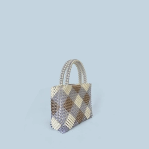 Close-up of handmade beaded tote bag featuring purple and white argyle pattern