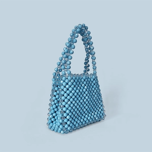 Detail of sky blue handmade beaded handbag featuring multifaceted geometric beads