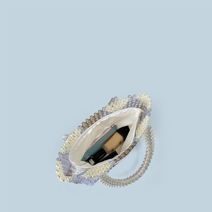 Top view of beaded handbag interior showing spacious capacity for phone and cosmetics