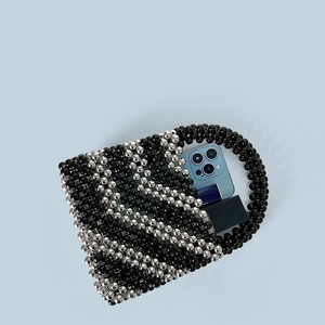 Top view of handmade beaded bucket bag showing internal capacity for phone and lipstick