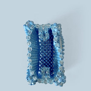 Detailed top view of handmade beaded handbag showing blue and crystal bead weaving texture