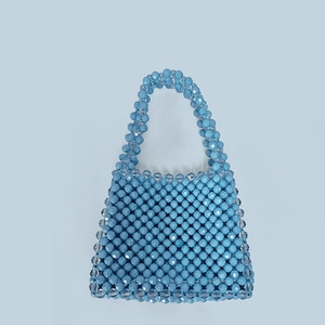 Detailed close-up of handmade blue beaded handbag showing woven bead pattern and texture