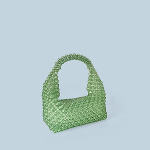 Detail of mint green handcrafted beaded tote bag showing intricate woven texture