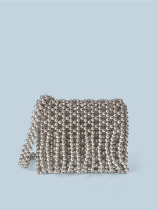 Detail of silver metallic beaded texture and woven craftsmanship on square crossbody bag