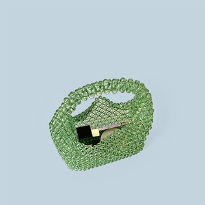 Detailed view of light green beaded tote bag showcasing interior capacity for cosmetics