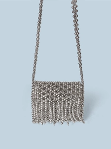 Detail of silver metallic beaded mini bag with handcrafted tassels and long strap