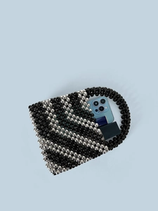 Retro beaded bucket bag with black and silver pearls showing interior storage space