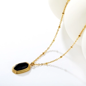 French vintage necklace with black agate pendant and 18k gold bead chain on white display