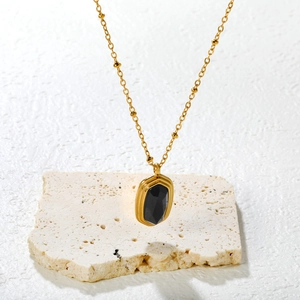 Retro gold satellite chain necklace with octagonal black onyx pendant on stone