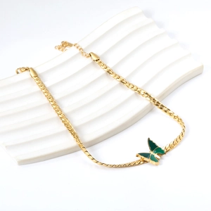 Golden stainless steel anklet with green enamel butterfly charm and chunky curb chain
