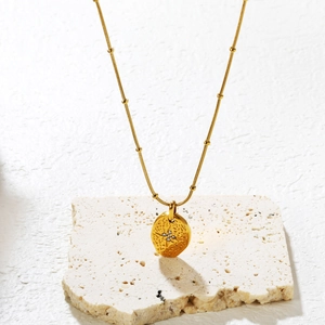 Collier doré avec pendentif pièce texturée orné de quatre zircons scintillants en étoile