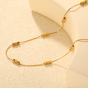 Minimalist gold stainless steel necklace with small square beads on fine chain link