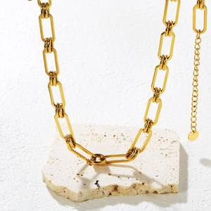 Gros plan détaillé du collier trombone plaqué or 18 carats avec fermoir mousqueton et logo