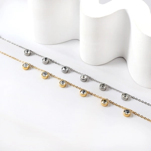 Detail of 18K gold and silver plated anklets with six sparkling bezel-set zircons