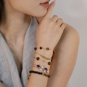 Tiger eye bead bracelet set with gold plated flower and pear cut crystal charms