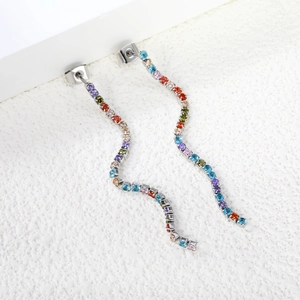 Detailed macro of long wavy tassel earrings featuring colorful zircon stones in silver