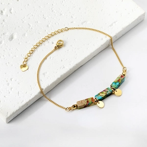 Golden chain anklet with three colorful stone beads and heart charm on white display