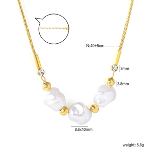Gold stainless steel necklace with baroque pearls and zircon accents on a white background