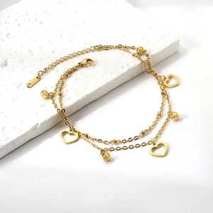 Golden double-layer stainless steel anklet with hollow hearts and beads on white stone