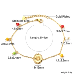 Detail of gold plated stainless steel anklet with colorful beads and sun pendant
