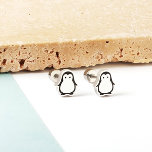 Close-up of cute penguin stud earrings with silver metal finish and flat screw backs