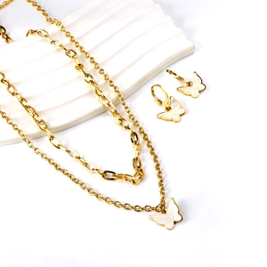 Golden butterfly shell double-layer necklace and earring jewelry set on white background