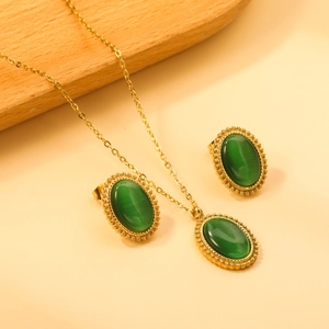 Vintage gold stainless steel jewelry set featuring oval green cat-eye stone necklace and earrings